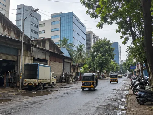 Old industrial sheds and new glass office blocks side by side in Andheri East