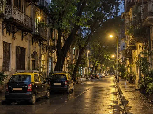 A quiet Colaba back lane of old buildings with wooden balconies at night