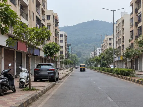 A quiet sector road with housing society buildings in Kamothe, Navi Mumbai, in the morning
