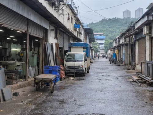 A lane of small workshops and parked tempos in Sakinaka in the morning